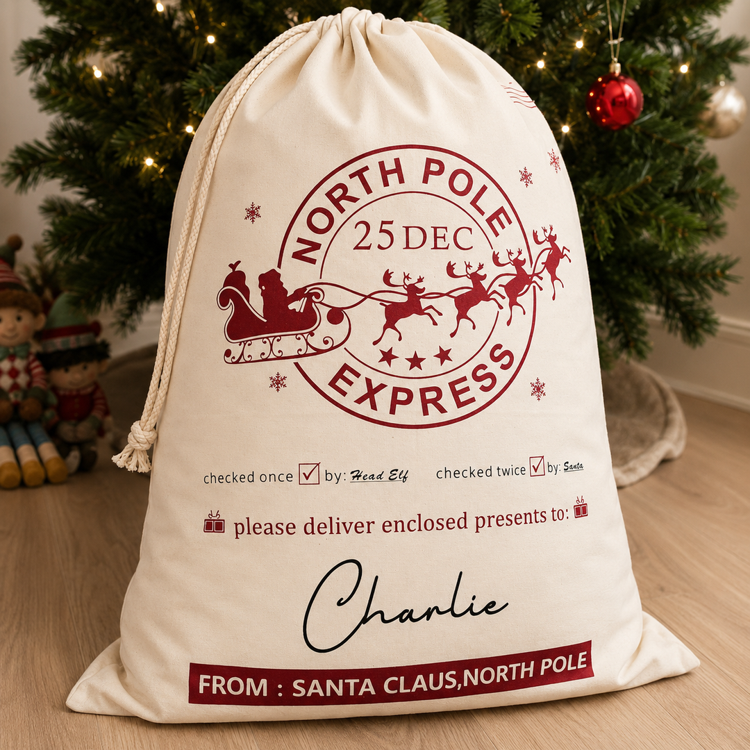 Medium personalised Santa Sack with Red North Pole writing against a Christmas Tree. 