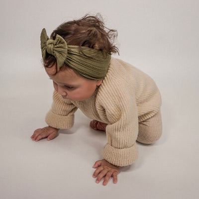 Babygirl wearing khaki Cable Knit Headband